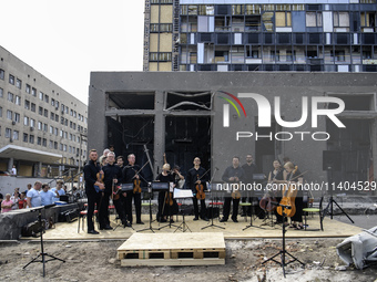 Conductor Herman Makarenko and the Kyiv Classic Orchestra are performing ''Requiem for the Dead'' at the ruins of Okhmatdyt Children's Hospi...