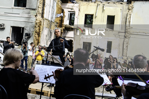 Conductor Herman Makarenko and the Kyiv Classic Orchestra are performing ''Requiem for the Dead'' at the ruins of Okhmatdyt Children's Hospi...