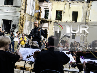 Conductor Herman Makarenko and the Kyiv Classic Orchestra are performing ''Requiem for the Dead'' at the ruins of Okhmatdyt Children's Hospi...