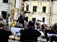 Conductor Herman Makarenko and the Kyiv Classic Orchestra are performing ''Requiem for the Dead'' at the ruins of Okhmatdyt Children's Hospi...