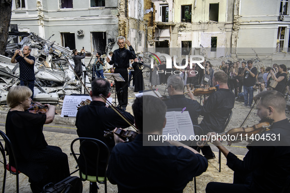 Conductor Herman Makarenko and the Kyiv Classic Orchestra are performing ''Requiem for the Dead'' at the ruins of Okhmatdyt Children's Hospi...