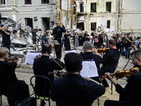 Conductor Herman Makarenko and the Kyiv Classic Orchestra are performing ''Requiem for the Dead'' at the ruins of Okhmatdyt Children's Hospi...