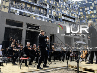 Conductor Herman Makarenko and the Kyiv Classic Orchestra are performing ''Requiem for the Dead'' at the ruins of Okhmatdyt Children's Hospi...