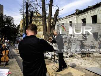 Conductor Herman Makarenko and the Kyiv Classic Orchestra are performing ''Requiem for the Dead'' at the ruins of Okhmatdyt Children's Hospi...