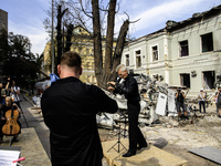 Conductor Herman Makarenko and the Kyiv Classic Orchestra are performing ''Requiem for the Dead'' at the ruins of Okhmatdyt Children's Hospi...