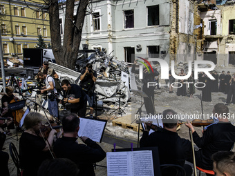 Conductor Herman Makarenko and the Kyiv Classic Orchestra are performing ''Requiem for the Dead'' at the ruins of Okhmatdyt Children's Hospi...