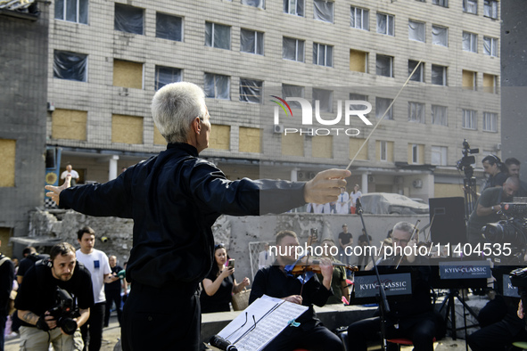 Conductor Herman Makarenko and the Kyiv Classic Orchestra are performing ''Requiem for the Dead'' at the ruins of Okhmatdyt Children's Hospi...