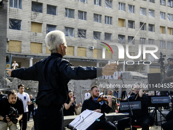 Conductor Herman Makarenko and the Kyiv Classic Orchestra are performing ''Requiem for the Dead'' at the ruins of Okhmatdyt Children's Hospi...