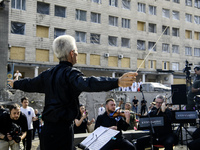 Conductor Herman Makarenko and the Kyiv Classic Orchestra are performing ''Requiem for the Dead'' at the ruins of Okhmatdyt Children's Hospi...