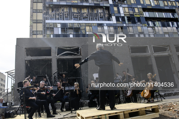 Conductor Herman Makarenko and the Kyiv Classic Orchestra are performing ''Requiem for the Dead'' at the ruins of Okhmatdyt Children's Hospi...