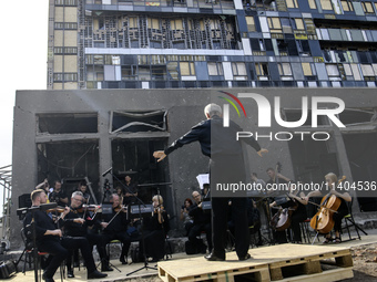 Conductor Herman Makarenko and the Kyiv Classic Orchestra are performing ''Requiem for the Dead'' at the ruins of Okhmatdyt Children's Hospi...