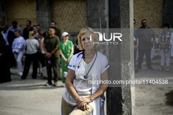 Medical workers are hearing as Conductor Herman Makarenko and the Kyiv Classic Orchestra are performing ''Requiem for the Dead'' at the ruin...