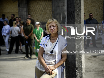 Medical workers are hearing as Conductor Herman Makarenko and the Kyiv Classic Orchestra are performing ''Requiem for the Dead'' at the ruin...