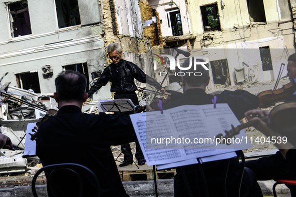 Conductor Herman Makarenko and the Kyiv Classic Orchestra are performing ''Requiem for the Dead'' at the ruins of Okhmatdyt Children's Hospi...