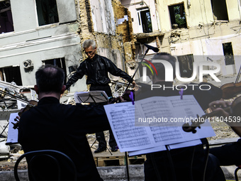 Conductor Herman Makarenko and the Kyiv Classic Orchestra are performing ''Requiem for the Dead'' at the ruins of Okhmatdyt Children's Hospi...