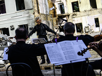 Conductor Herman Makarenko and the Kyiv Classic Orchestra are performing ''Requiem for the Dead'' at the ruins of Okhmatdyt Children's Hospi...