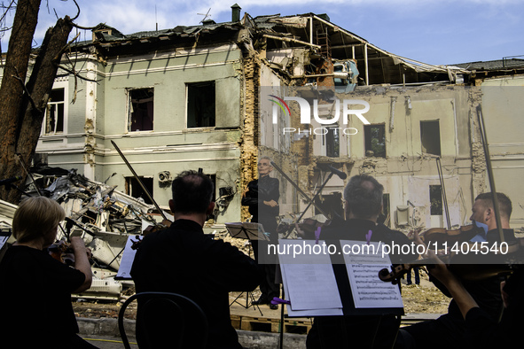 Conductor Herman Makarenko and the Kyiv Classic Orchestra are performing ''Requiem for the Dead'' at the ruins of Okhmatdyt Children's Hospi...