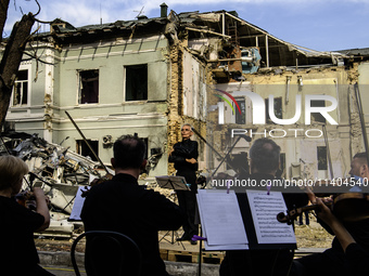 Conductor Herman Makarenko and the Kyiv Classic Orchestra are performing ''Requiem for the Dead'' at the ruins of Okhmatdyt Children's Hospi...