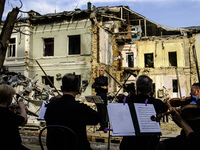 Conductor Herman Makarenko and the Kyiv Classic Orchestra are performing ''Requiem for the Dead'' at the ruins of Okhmatdyt Children's Hospi...