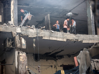 Palestinians are assessing the damage following an Israeli strike in the Nuseirat refugee camp in the central Gaza Strip on July 13, 2024, a...