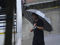 A pedestrian is traveling in the heavy rainfall with an umbrella in Kirtipur, Kathmandu, Nepal, on July 12, 2024. (