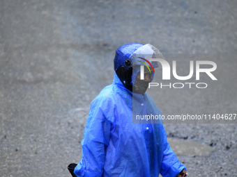 A pedestrian is traveling in the heavy rainfall in Kirtipur, Kathmandu, Nepal, on July 12, 2024. (