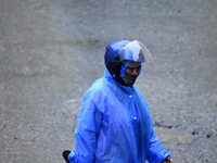 A pedestrian is traveling in the heavy rainfall in Kirtipur, Kathmandu, Nepal, on July 12, 2024. (