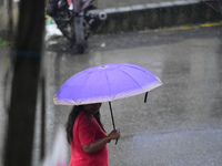 A pedestrian is traveling in the heavy rainfall with an umbrella in Kirtipur, Kathmandu, Nepal, on July 12, 2024. (