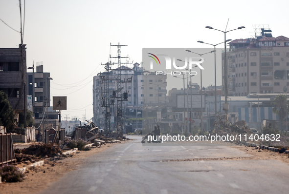 Palestinians are walking on Salah al-Din Road in the Nuseirat refugee camp in the central Gaza Strip on July 13, 2024, amid the ongoing conf...