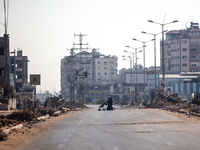 Palestinians are walking on Salah al-Din Road in the Nuseirat refugee camp in the central Gaza Strip on July 13, 2024, amid the ongoing conf...