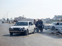 Palestinians are walking on Salah al-Din Road in the Nuseirat refugee camp in the central Gaza Strip on July 13, 2024, amid the ongoing conf...