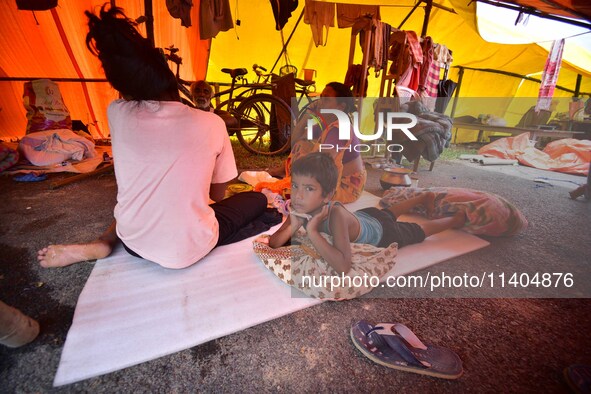 Flood-affected people are staying in a makeshift shelter in Nagaon District, Assam, India, on July 13, 2024. 