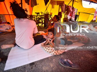 Flood-affected people are staying in a makeshift shelter in Nagaon District, Assam, India, on July 13, 2024. (