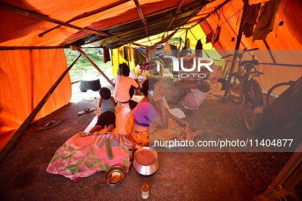 Flood-affected people are staying in a makeshift shelter in Nagaon District, Assam, India, on July 13, 2024. 