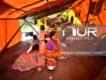 Flood-affected people are staying in a makeshift shelter in Nagaon District, Assam, India, on July 13, 2024. (