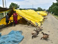 Flood-affected people are staying near their makeshift shelter in Nagaon District of Assam, India, on July 13, 2024. (