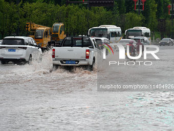 Citizens are traveling on a flooded road in Neijiang, Sichuan province, China, on July 13, 2024. (