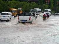 Citizens are traveling on a flooded road in Neijiang, Sichuan province, China, on July 13, 2024. (