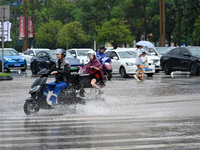 Citizens are traveling on a flooded road in Neijiang, Sichuan province, China, on July 13, 2024. (