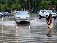 Citizens are traveling on a flooded road in Neijiang, Sichuan province, China, on July 13, 2024. (