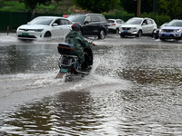 Citizens are traveling on a flooded road in Neijiang, Sichuan province, China, on July 13, 2024. (