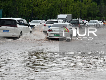 Citizens are traveling on a flooded road in Neijiang, Sichuan province, China, on July 13, 2024. (