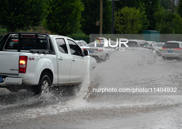 Citizens are traveling on a flooded road in Neijiang, Sichuan province, China, on July 13, 2024. 