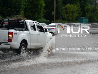 Citizens are traveling on a flooded road in Neijiang, Sichuan province, China, on July 13, 2024. (