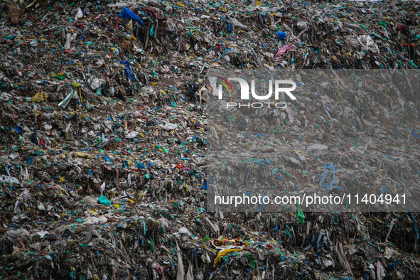 Heaps of garbage are being seen at an open garbage dumping site in Srinagar, Jammu and Kashmir, on July 13, 2024. The improper disposal of w...