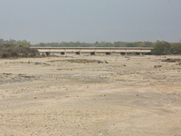 A bridge is spanning a river that is completely drying up in Najibabad, Uttar Pradesh, India, on April 19, 2024. (