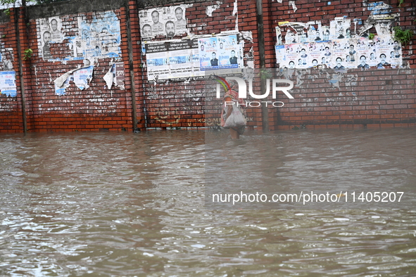 People and vehicles are trying to move through the waterlogged street in Dhaka, Bangladesh, on July 26, 2024 