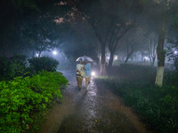 Citizens are walking through the rainstorm in central Chongqing, China, on July 13, 2024. (