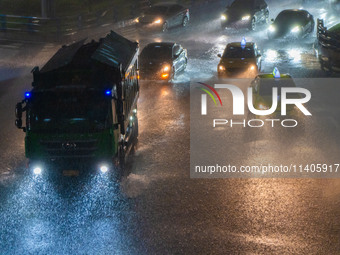 Citizens are walking through the rainstorm in central Chongqing, China, on July 13, 2024. (