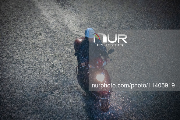 Citizens are walking through the rainstorm in central Chongqing, China, on July 13, 2024. 